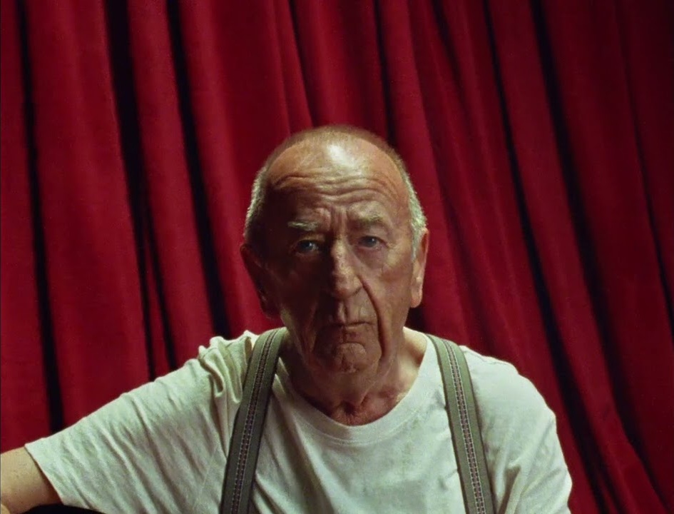 Frank Watkinson in front of a red curtain in KFC's Surrender to Tender advert