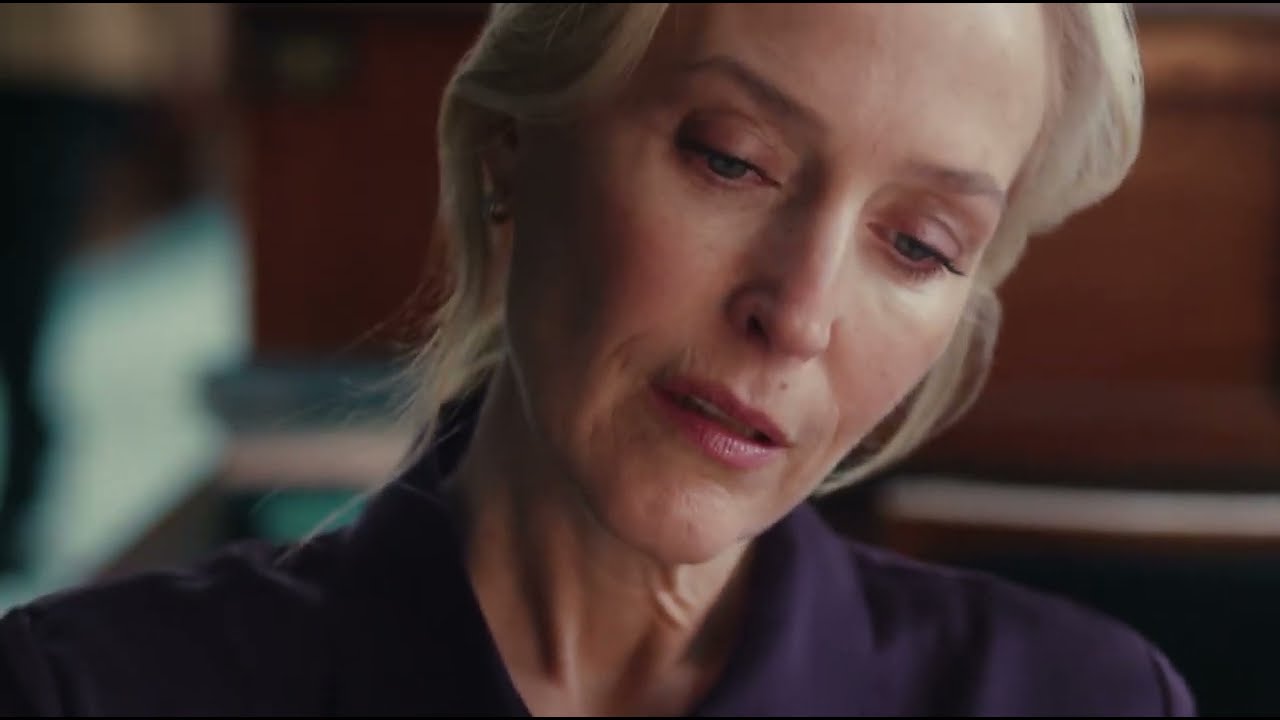 Gillian Anderson reading in a library in the M&S autumn 2026 fashion advert