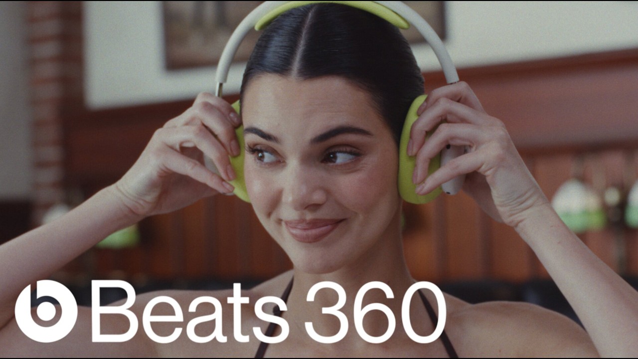 Kendall Jenner wearing lime green Beats 360 headphones in the launch advert