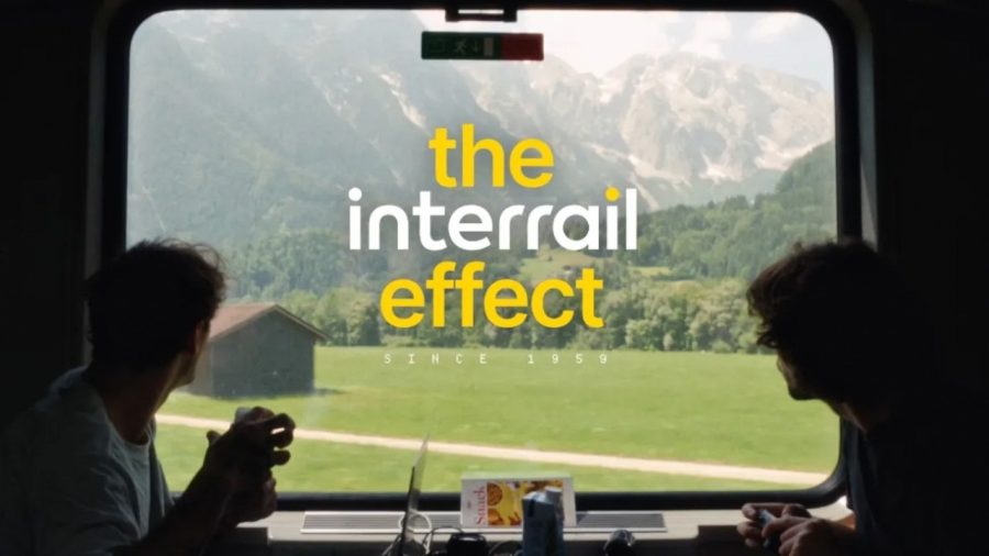 A traveller looks out of a train window at the Alps in Interrail's The Interrail Effect film