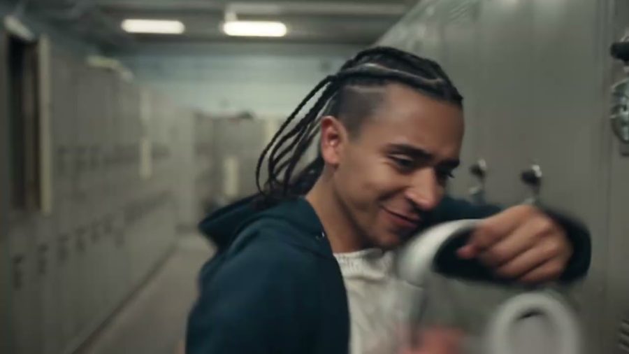 A young man holds up a pair of headphones in a locker room in Amazon's Prime Big Deal Days advert