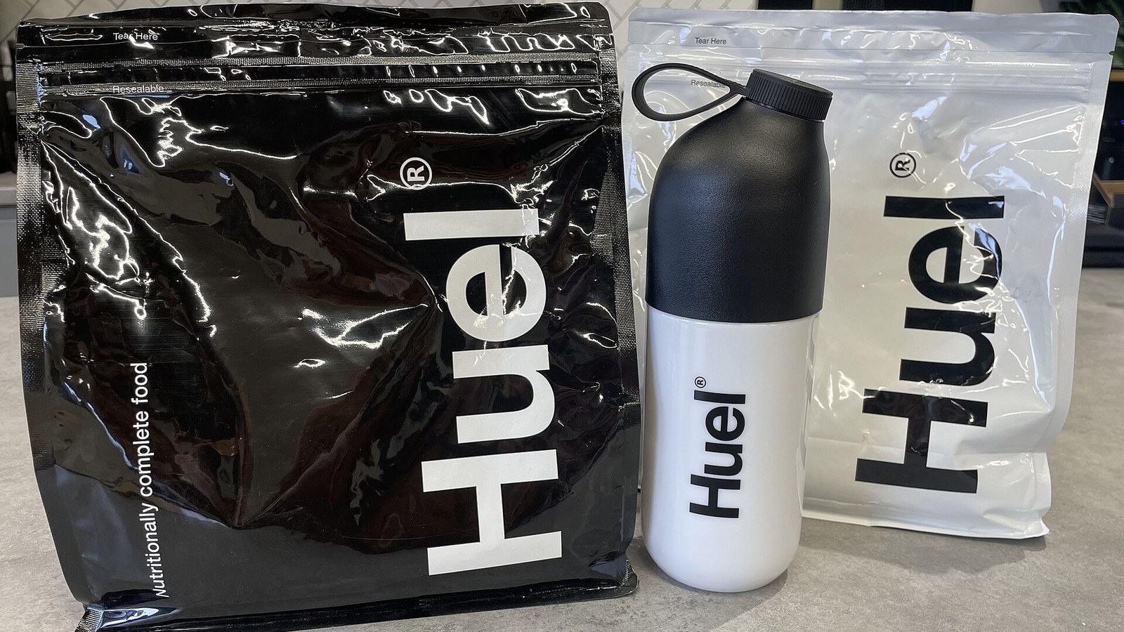 Bags of Huel powder and a Huel shaker bottle