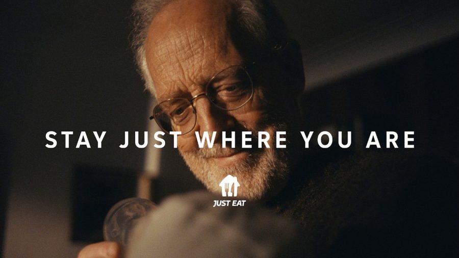 A grandfather looking at his newborn grandchild, with the line Stay Just Where You Are, from Just Eat's advert