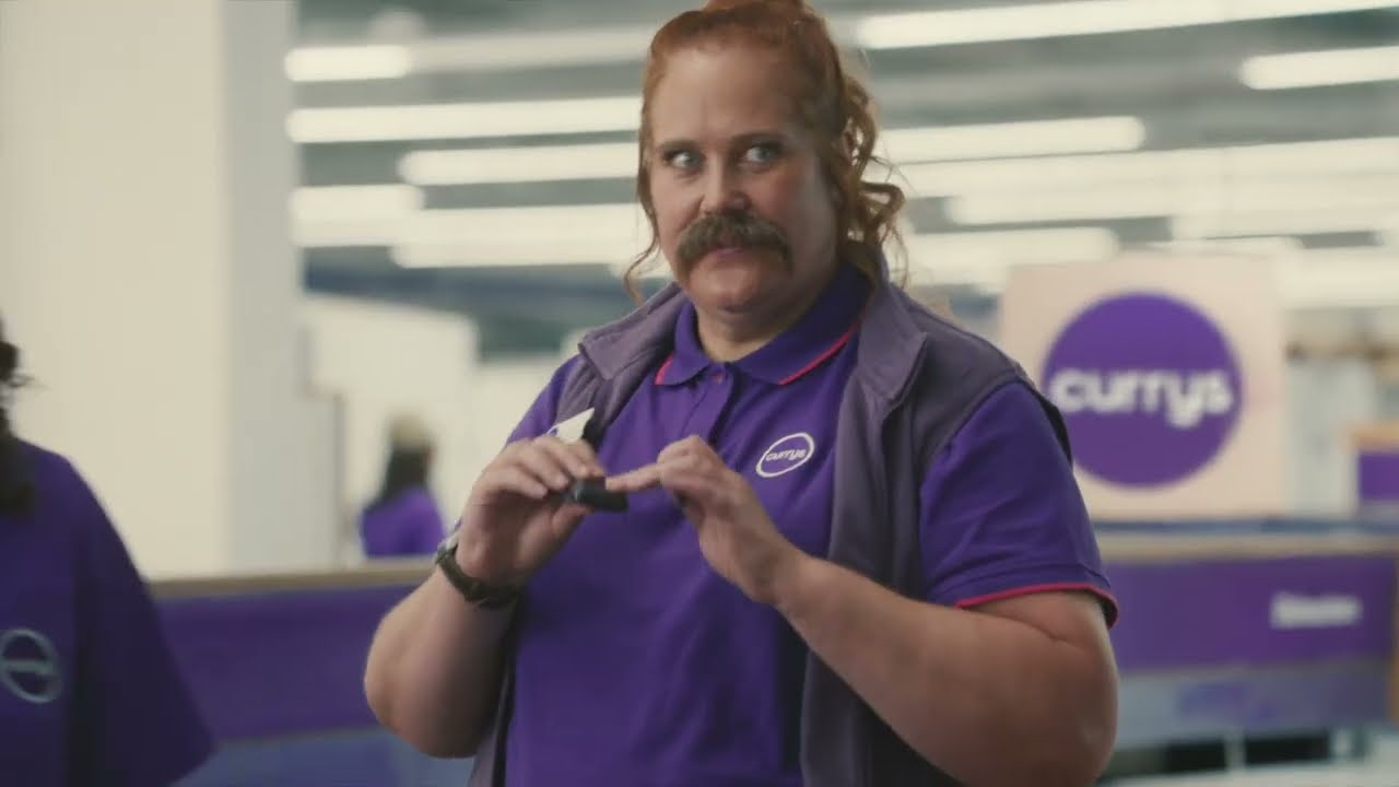 A Currys colleague with a moustache in a Beyond Techspectations advert