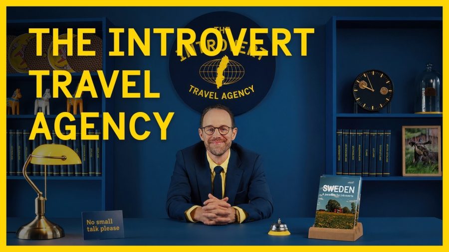 A travel agent at the desk of The Introvert Travel Agency in Visit Sweden's film