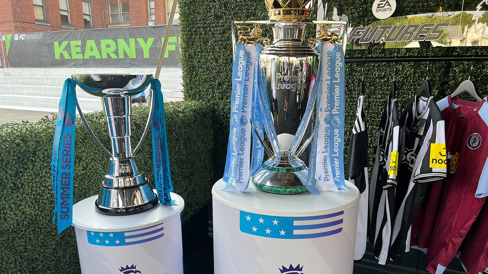 The Premier League trophy on display beside the Summer Series trophy