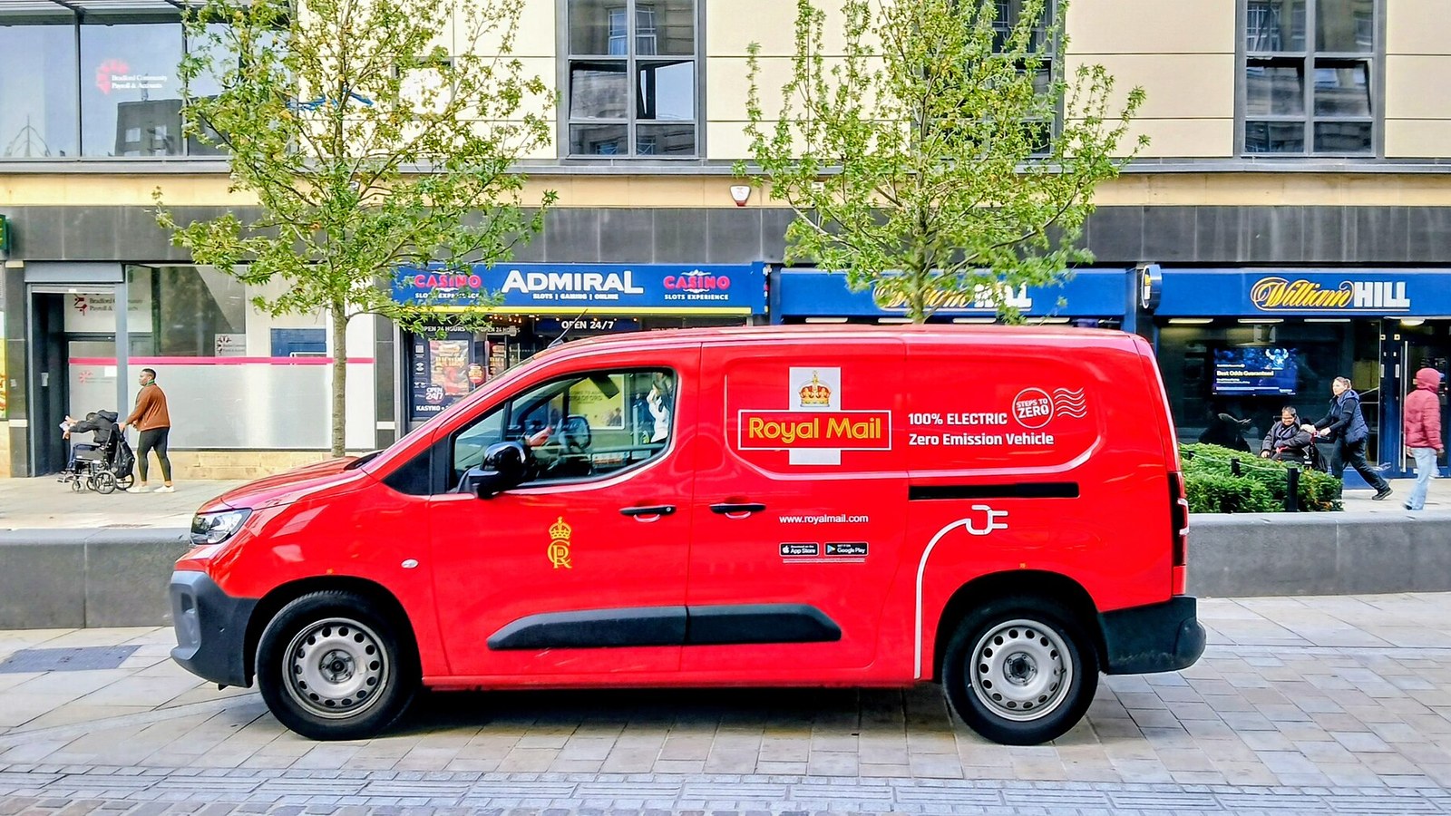 An electric Royal Mail delivery van parked in Bradford city centre