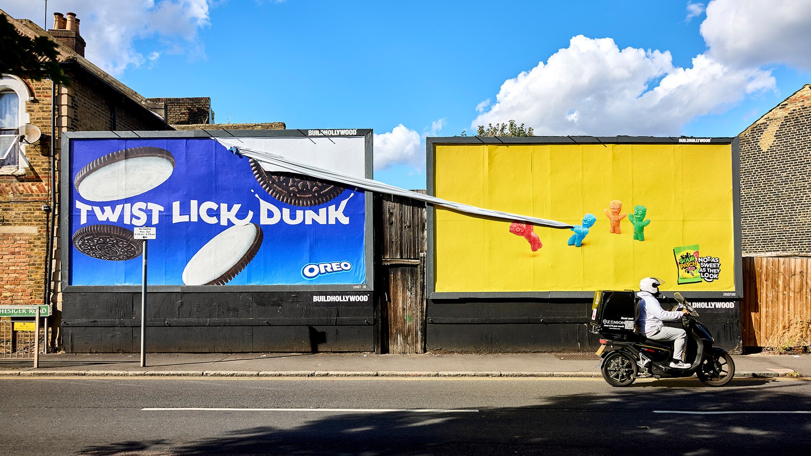 Sour Patch Kids billboard where the sweets pull a strip off the neighbouring Oreo poster