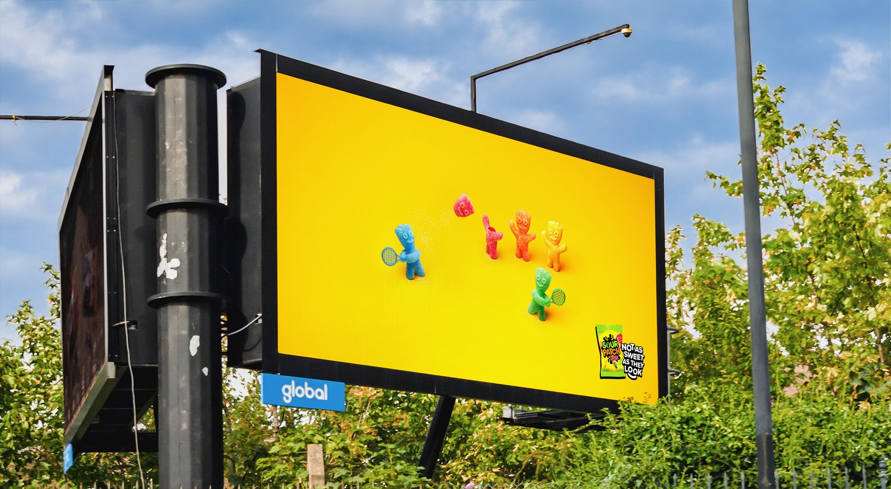 Sour Patch Kids billboard showing the sweets playing tennis with a severed head