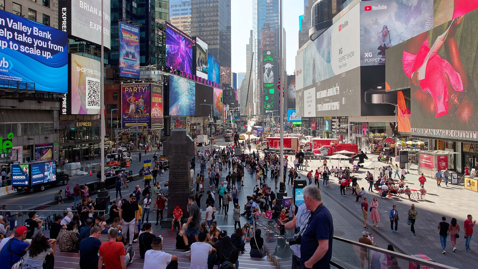 Digital advertising screens above crowds in Times Square, New York