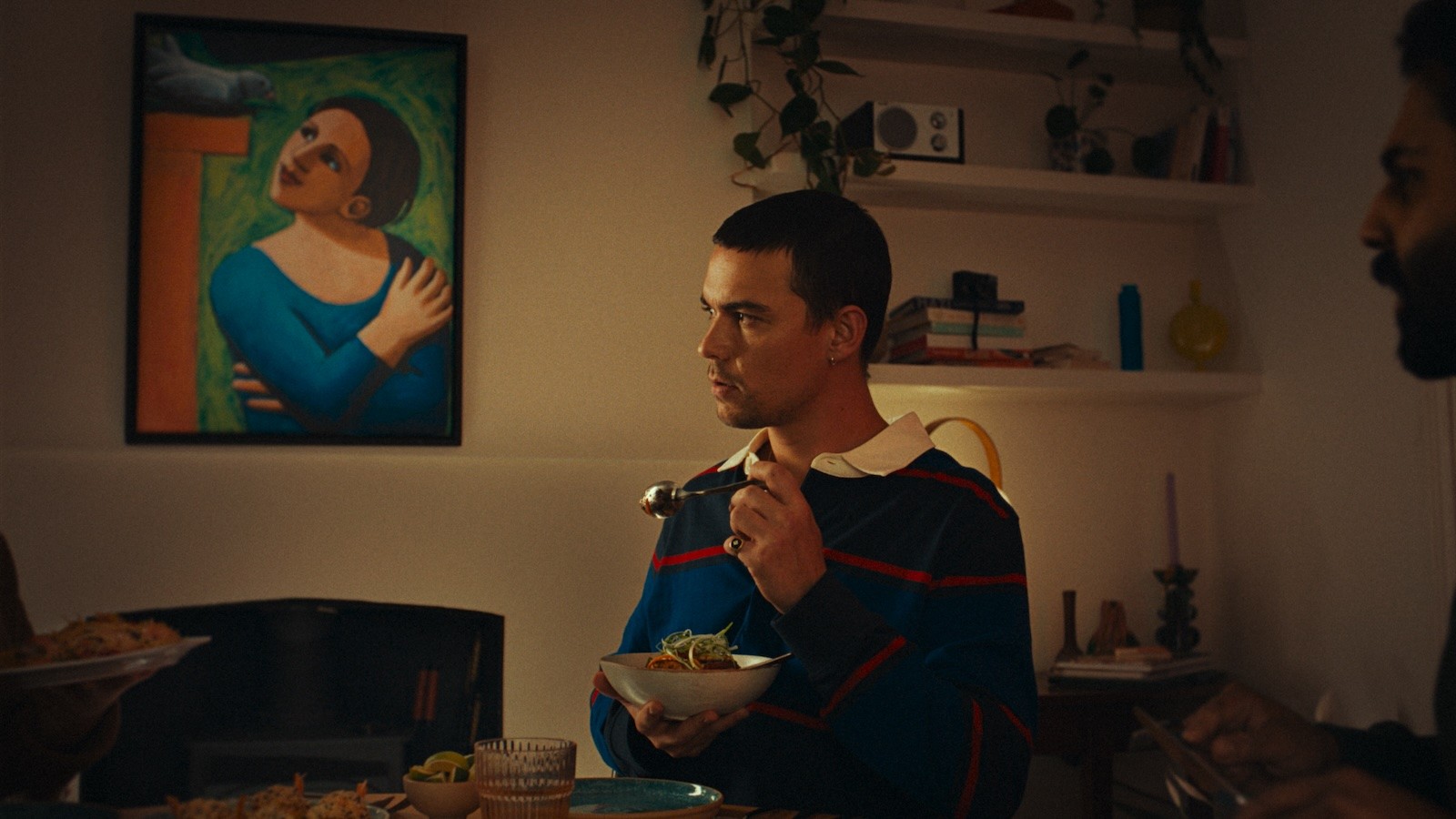 A man eating noodles at a dinner table in Waitrose's fine Dine In advert